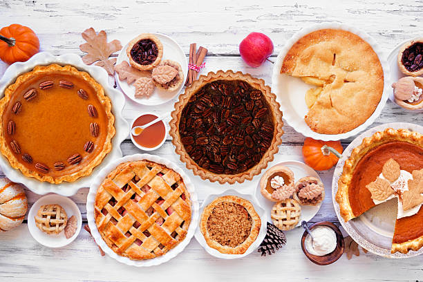 Homemade autumn pie table scene. Top down view on a white wood background. stock photo