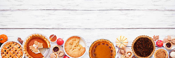 istock Homemade fall pie bottom border. Top view on a white wood banner background. 2237731933