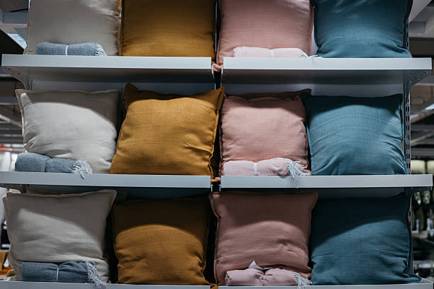 Many pillows on shelves in a shopping mall, creating an atmosphere of coziness and variety.