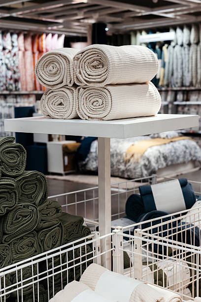 istock Neatly folded throws on a shelf in the supermarket's textile section 2237738540
