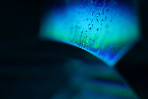 istock Blue reflections of liquid in macro, bright liquid surface on black background, geometric shapes 2237739049