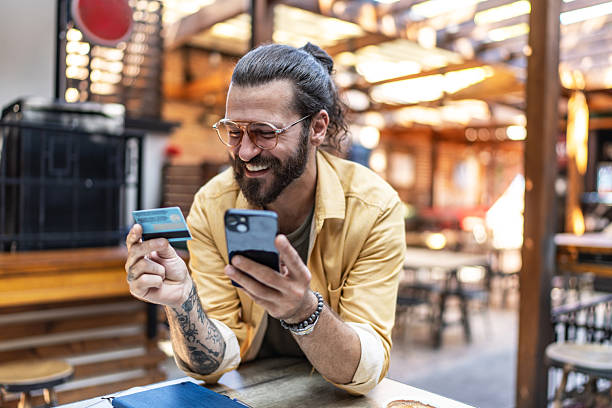 istock Man shopping online using smartphone and credit card 2237740255