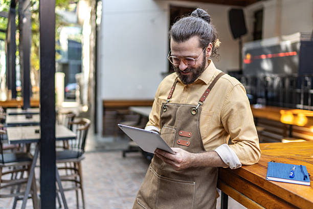 istock Restaurant owner managing small business using digital tablet 2237740522