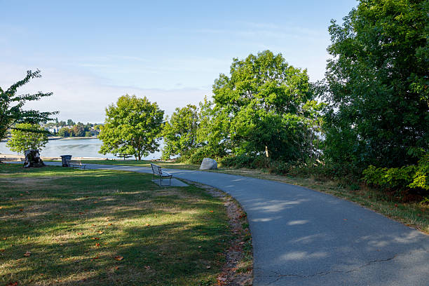 istock Serene park path in Kitsilano with a bench overlooking a calm water 2237742072