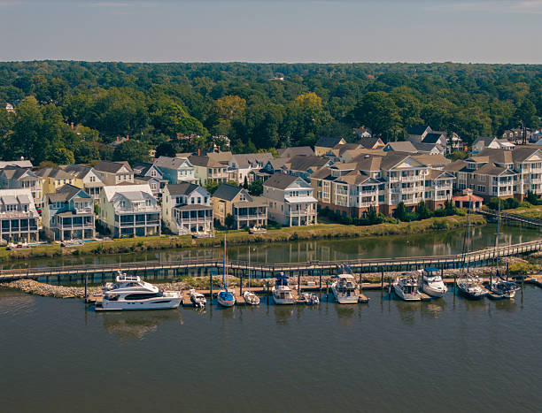 istock New Water Front Coastal Homes - Dock Boats and Boardwalk 2237742121