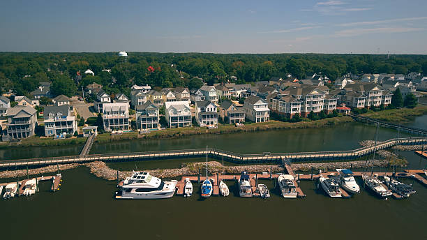 istock New Water Front Coastal Homes - Dock Boats and Boardwalk 2237742445