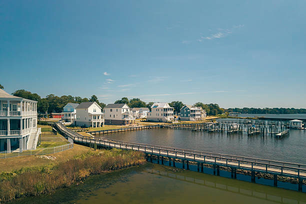 Views from the park of the current Roanoke Marshes Lighthouse and residential buildings along the waterfront of Manteo Harbor in Manteo, Outer Banks, North Carolina, USA.