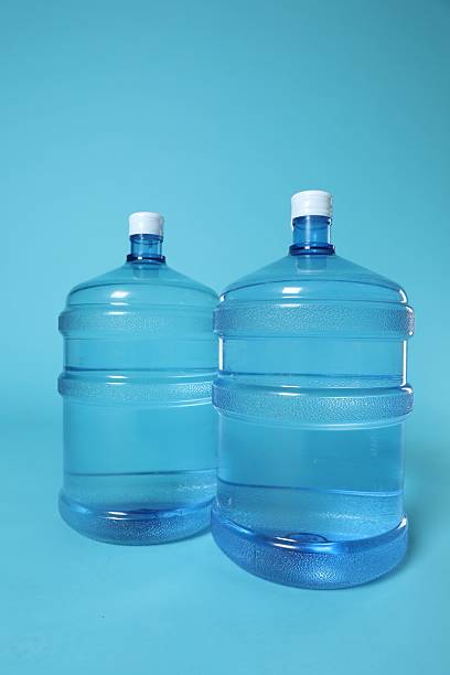 istock Cooler bottles with water on light blue background 2237746530