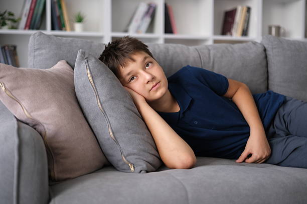 little boy lying on the couch