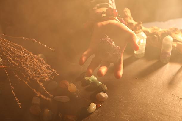 istock Woman doing ritual with healing stones at dark table, closeup 2237757152