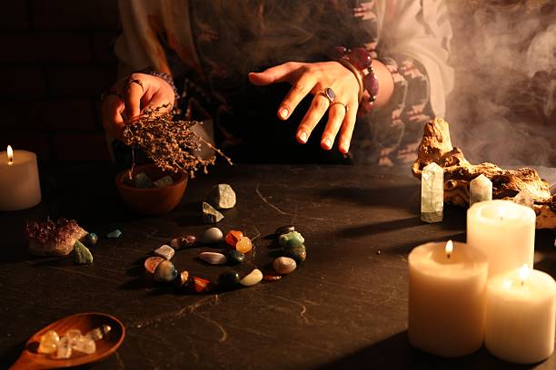 istock Woman doing ritual with healing stones at dark table, closeup 2237757184