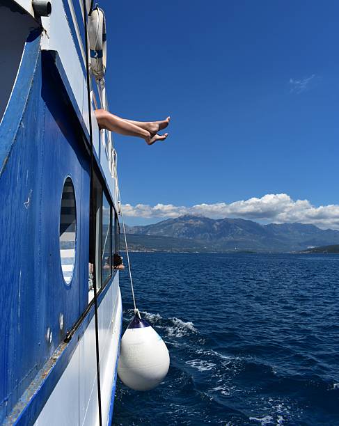Feeling liberated during the ferry ride in Montenegro with mountain view  on the background