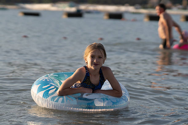istock girl swimming on an inflatable ring 2237760501