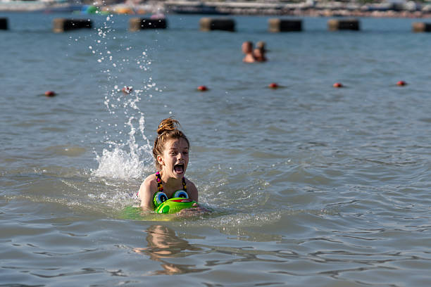 Woman having fun in the lake at sunset
