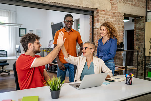 istock Diverse business team celebrating success with high five 2237761418
