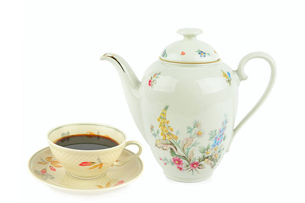 Close-up shot of unrecognizable senior man pouring sugar into tea while relaxing with his wife in the living room at home