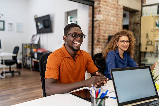 istock Diverse business people collaborating in modern office laughing 2237762117