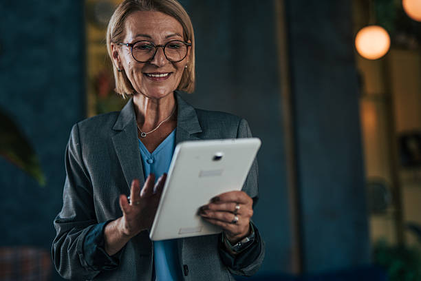 istock Mature businesswoman using digital tablet with a happy expression 2237763508
