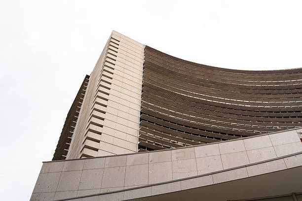 Modern brutalist building featuring curved concrete facade and strong lines