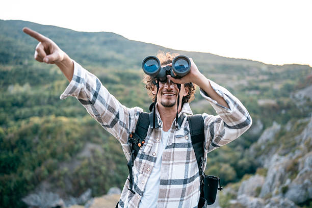 istock Hiker With Binoculars Pointing Forward On Mountain Trail, Outdoor Adventure And Exploration Experience 2237774463