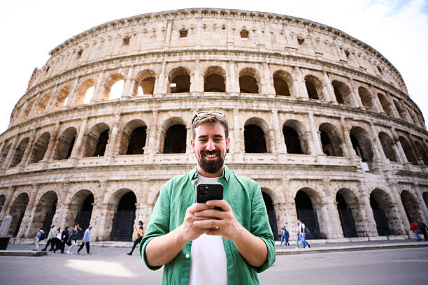 istock Caucasian man using smartphone outside the Colosseum in Rome 2237777692