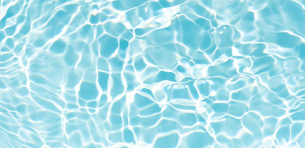istock Blue water with ripples on the surface. Defocus blurred transparent blue colored clear calm water surface texture with splashes and bubbles. Water waves with shining pattern texture background. 2237795409