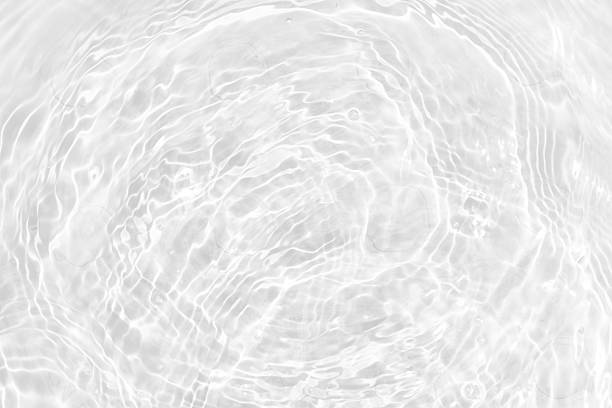 istock White water with ripples on the surface. Defocus blurred transparent white colored clear calm water surface texture with splashes and bubbles. Water waves with shining pattern texture background. 2237795430