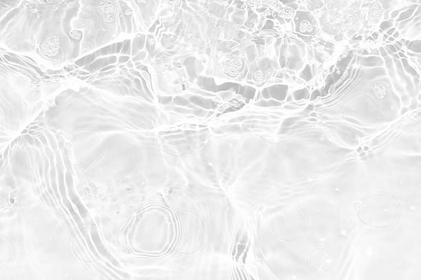 istock White water with ripples on the surface. Defocus blurred transparent white colored clear calm water surface texture with splashes and bubbles. Water waves with shining pattern texture background. 2237795431