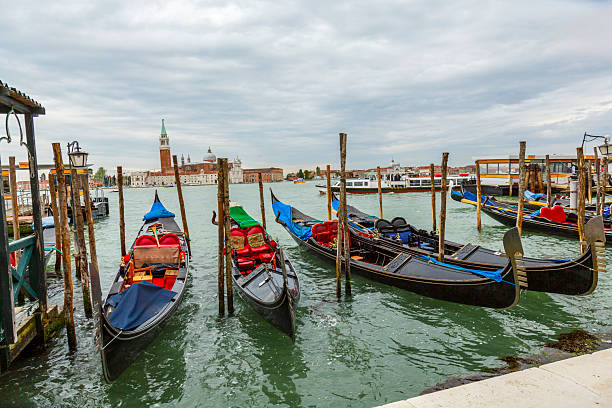 Travel destination: Venetian gondolas moored in a canal in Venice, Italy.