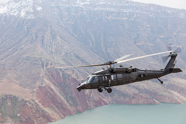 UH-60 Black Hawk Military Helicopter flying over river