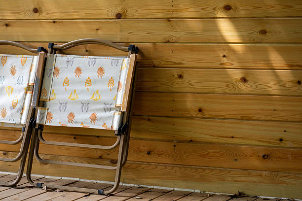 Wide side shot view of senior lady spending time on her rocking chair on her home's porch.