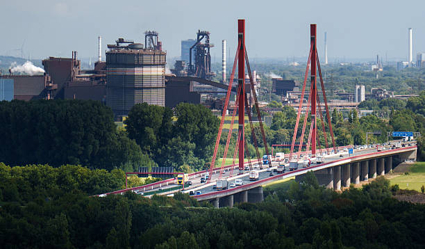 Germany, North Rhine Westphalia, Duisburg September 05, 2025 Bridge Industrial Background Rhine River factory landscape