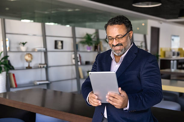 istock Businessman looks at tablet with joyful expression 2237819665