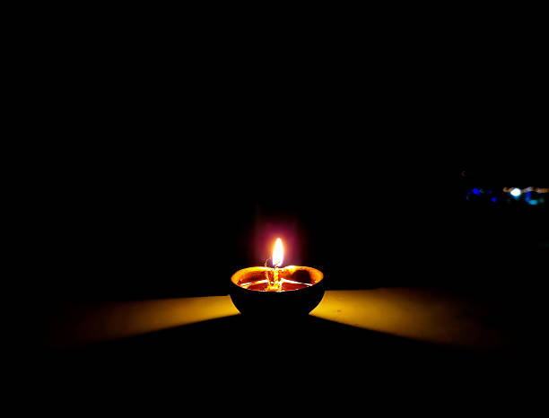 istock Single Clay Oil Lamp Glowing in Darkness 2237821701