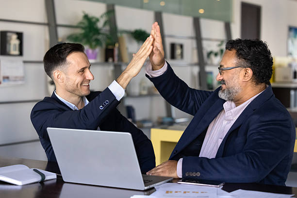 istock Two business partners enthusiastically giving each other high five 2237821806