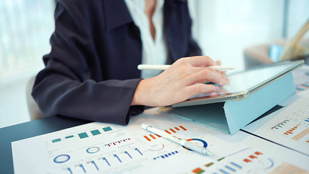 istock collaborative financial planning hands of female advisors working with digital tablets and physical documents for comprehensive analysis  leveraging technology and paperwork for detailed financial assessment 2237827502
