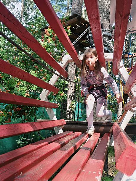 Asian little girl playing in summer countryside home garden