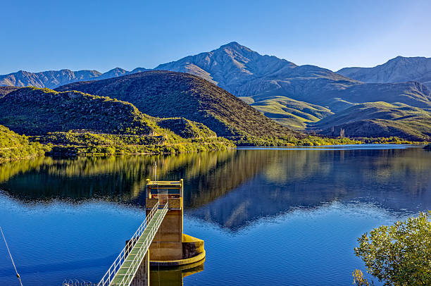 Koos Raubenheimer dam in the Little Karoo with water extraction tower serving the town of Oudtshoorn, Western Cape with Swartberg Mountain backdrop