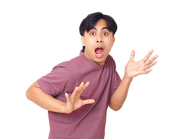 istock Funny young Asian man with open mouth and raised hands showing shocked reaction while looking at camera on plain background, perfect for emotion and lifestyle concept. 2237838355