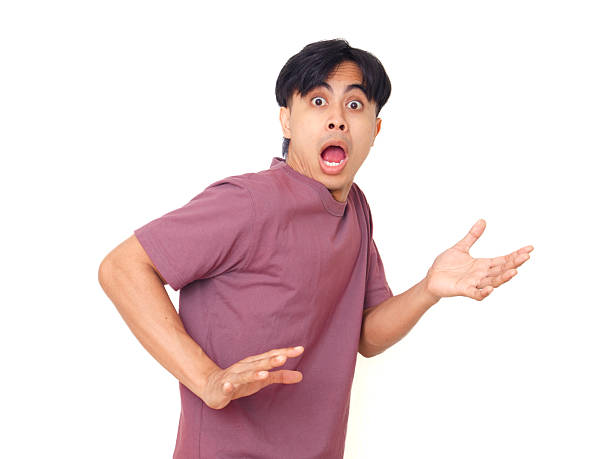 istock Funny young Asian man with open mouth and raised hands showing shocked reaction while looking at camera on plain background, perfect for emotion and lifestyle concept. 2237838513