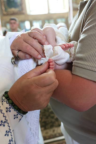 istock Baptism ceremony. Priest performs chrismation of newborn 2237838826