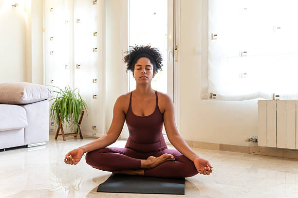 istock Woman meditating at home practicing yoga for wellness 2237841781