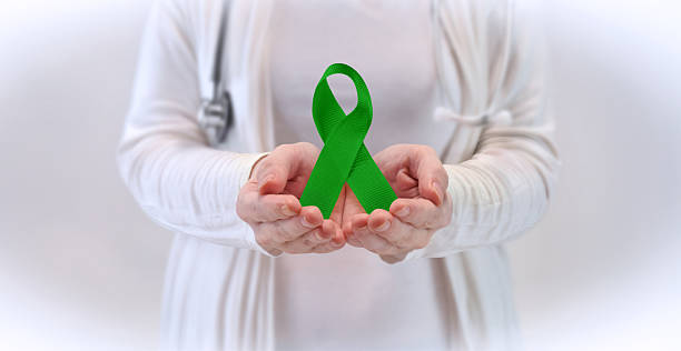 istock Awareness Concept with Doctor Presenting Green Ribbon 2237842153