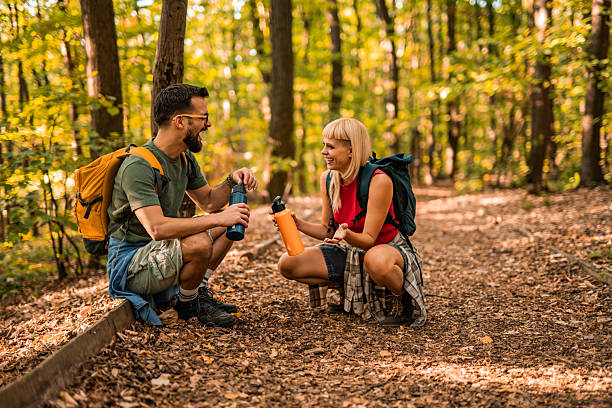 istock Happy couple having fun while hiking together in a forest. 2237845472
