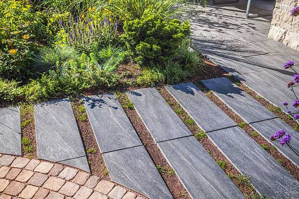 istock Path with large stone slabs through a beautifully planted garden 2237845901