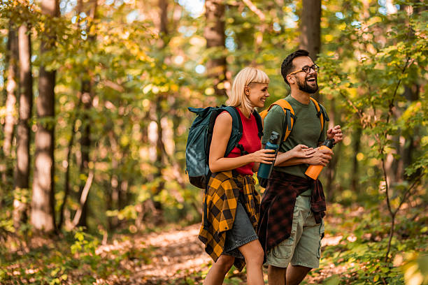 istock Happy couple walking together in a forest. 2237845934