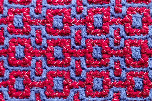 istock Crochet light blue pink geometric pattern. Crochet mosaic pattern close up. Volume square ornament. Knitted background. 2237846193