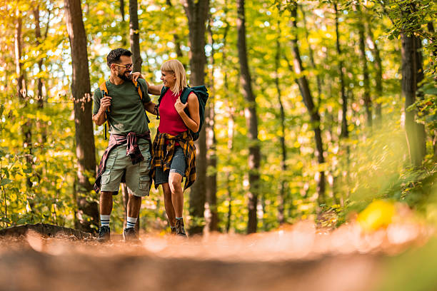 istock Happy couple walking together in a forest. 2237846406
