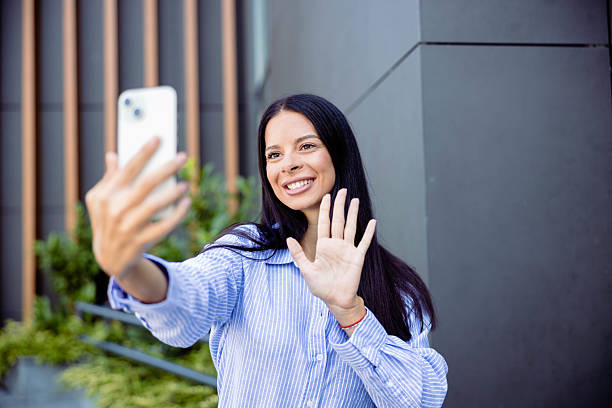 istock Smiling woman taking a selfie outdoors 2237846948
