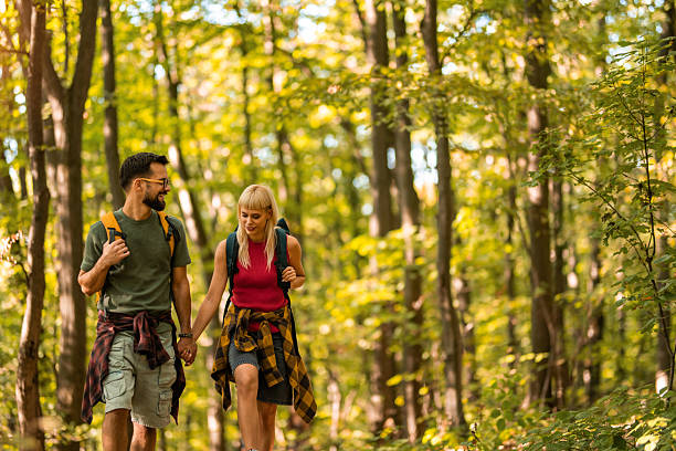 istock Happy couple walking together in a forest. 2237847473